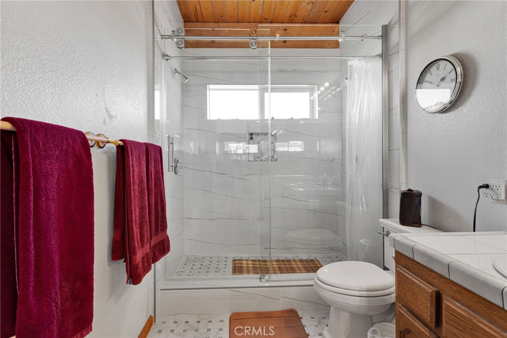 10328 El Centro Road Oak Hills, CA 92344 - Photo 18 of 43 a bathroom with a toilet a sink and shower