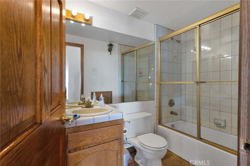 10328 El Centro Road Oak Hills, CA 92344 - Photo 22 of 43 a bathroom with a sink toilet and shower