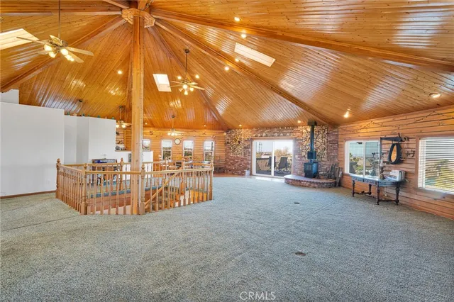 a view of a room with gym equipment and a chandelier