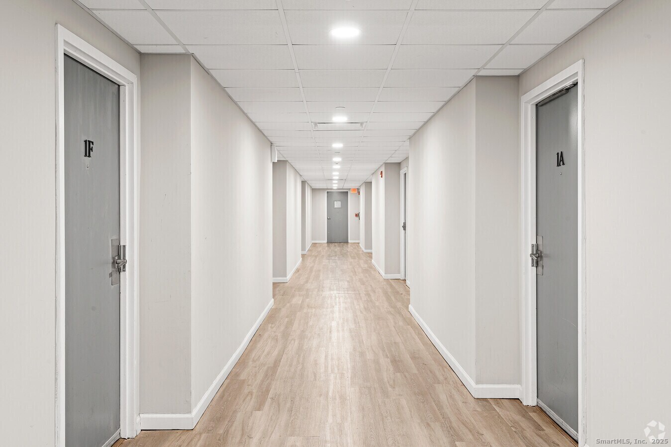 225 Lordship Boulevard, Unit 1F Stratford, CT 06615 - Photo 11 of 19 a view of hallway with wooden floor