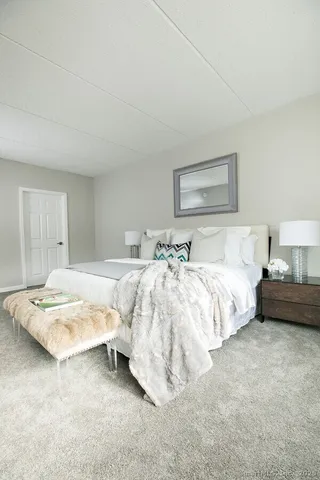 a bedroom with bed and a night stand