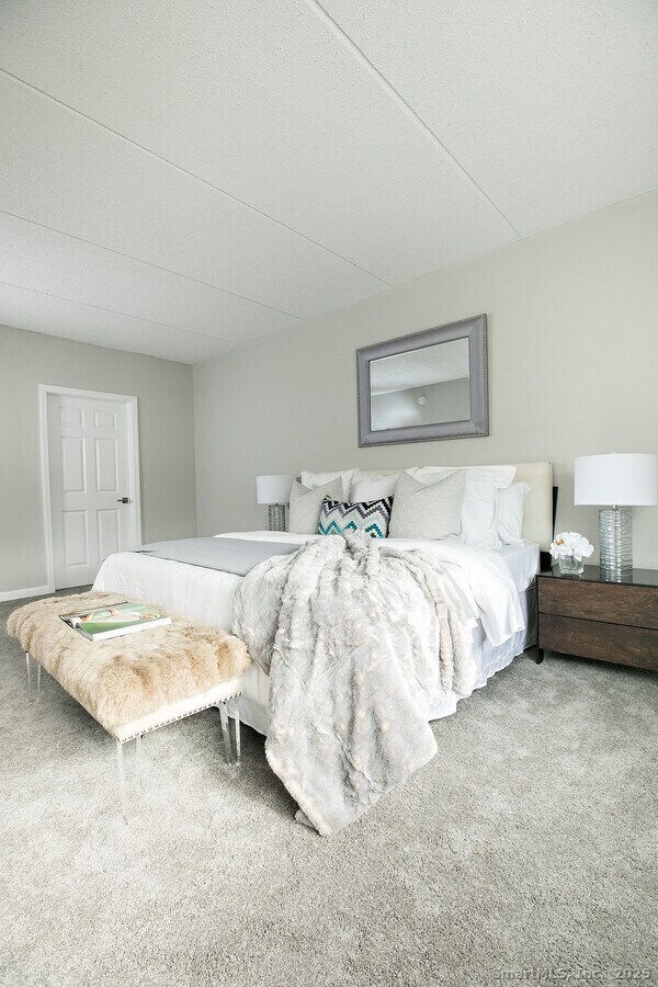 225 Lordship Boulevard, Unit 1F Stratford, CT 06615 - Photo 6 of 19 a bedroom with bed and a night stand