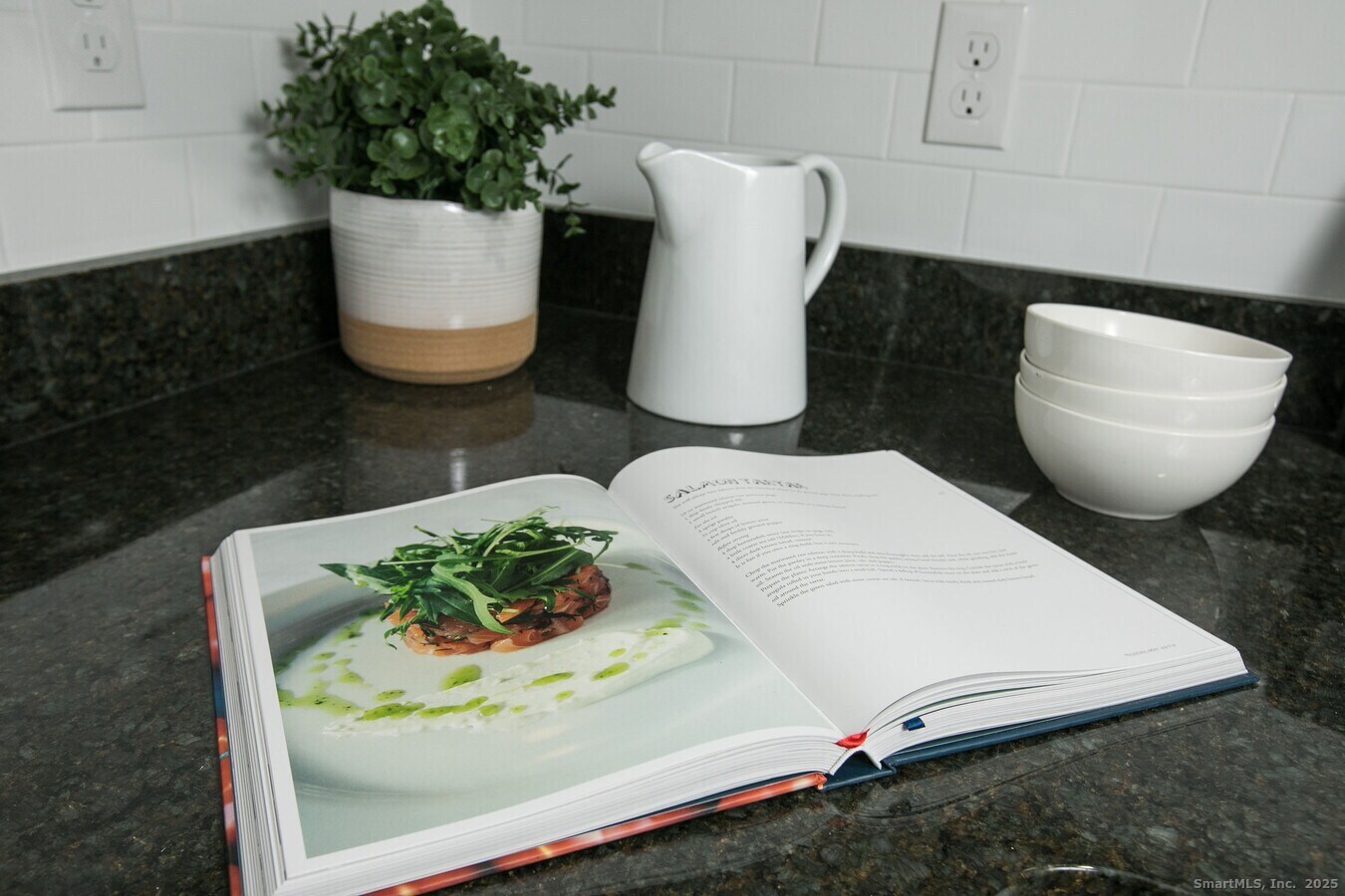 225 Lordship Boulevard, Unit 1F Stratford, CT 06615 - Photo 8 of 19 a picture of a room with wooden floor and lots of potted plants