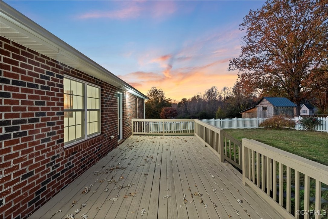 3420 Ceasar Town Road Powhatan, VA 23139 - Photo 2 of 50 Deck at dusk featuring a lawn