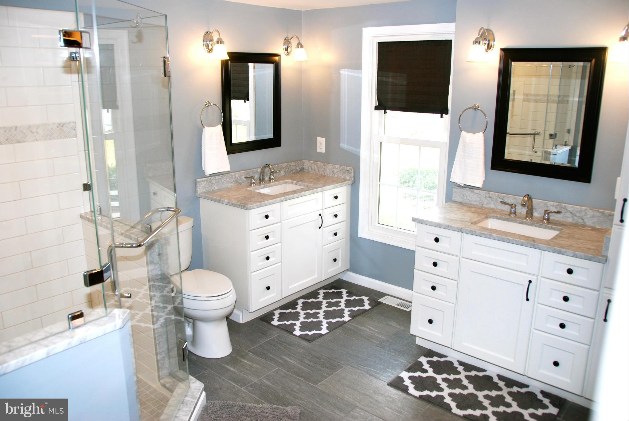 3112 Newcastle Lane Riva, MD 21140 - Photo 10 of 27 a bathroom with a double vanity sink toilet mirror and shower