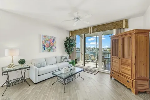 a living room with furniture and a floor to ceiling window