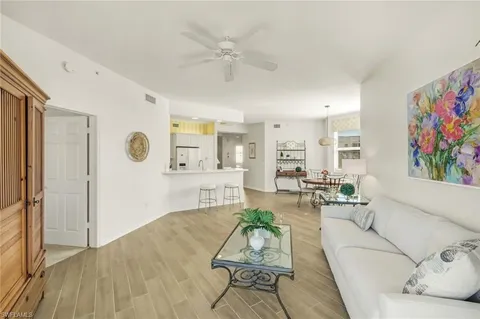 a living room with furniture potted plant and a table