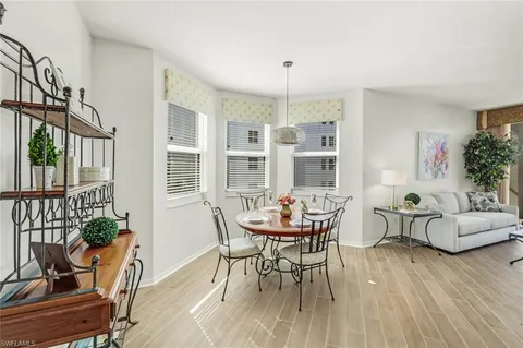 a kitchen with kitchen island a sink cabinets and wooden floor