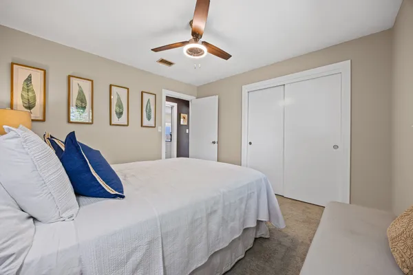 a bedroom with a large bed and a chandelier