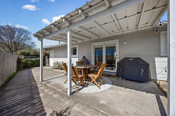 a building outdoor space with patio furniture and potted plants