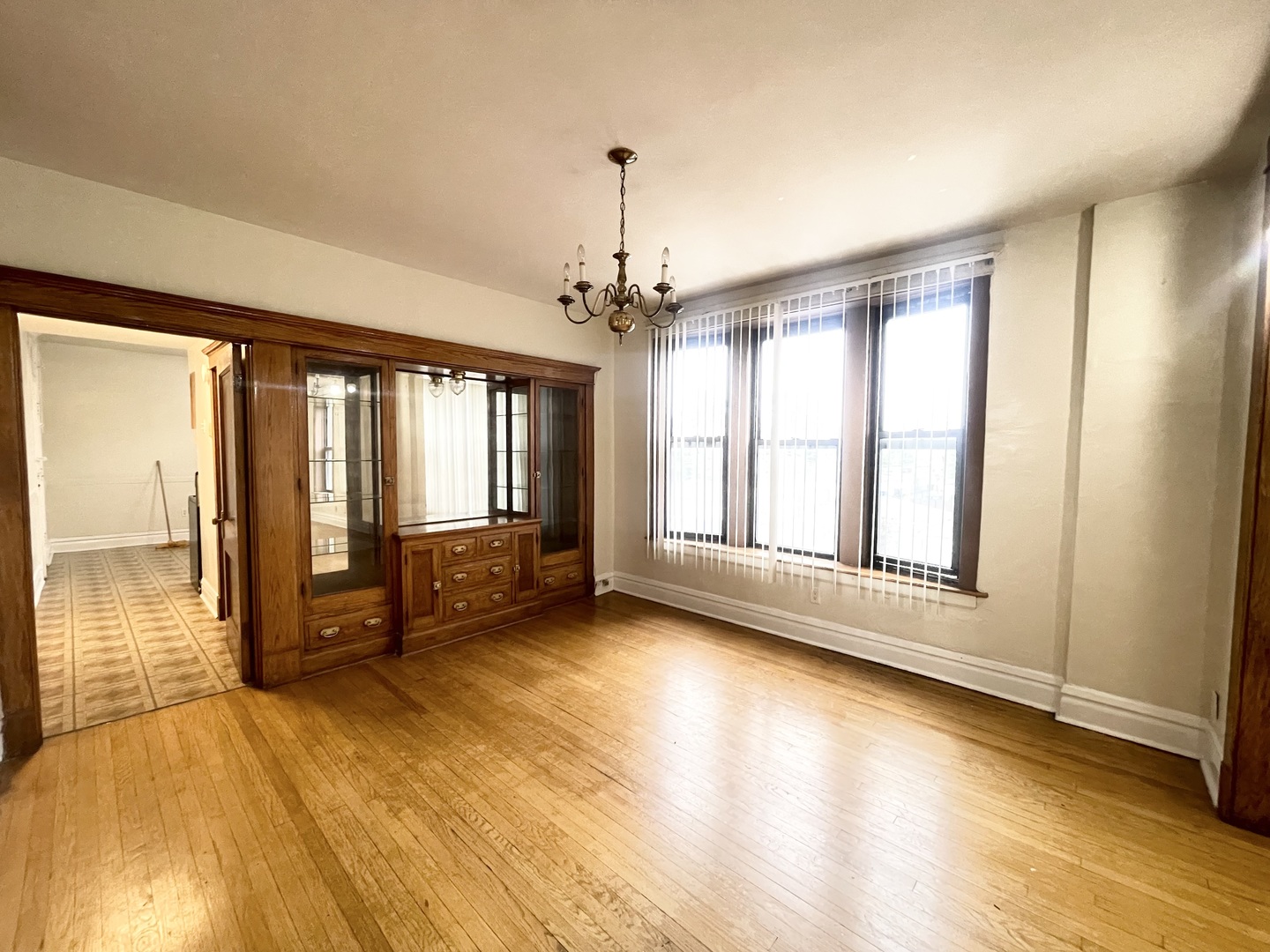 3270 West Dickens Avenue, Unit 2 Chicago, IL 60647 - Photo 5 of 15 an empty room with wooden floor and windows