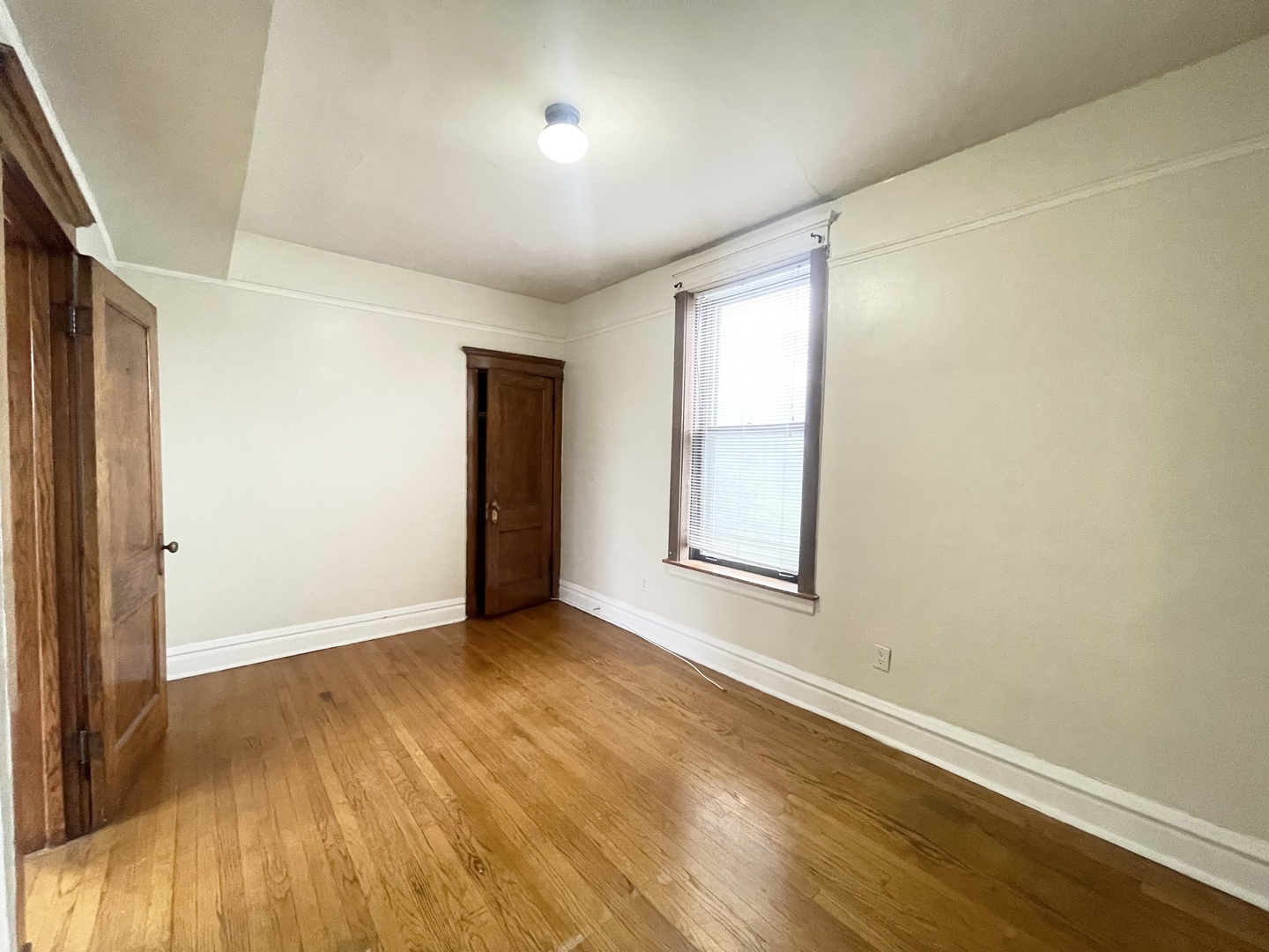 3270 West Dickens Avenue, Unit 2 Chicago, IL 60647 - Photo 7 of 15 an empty room with wooden floor and windows