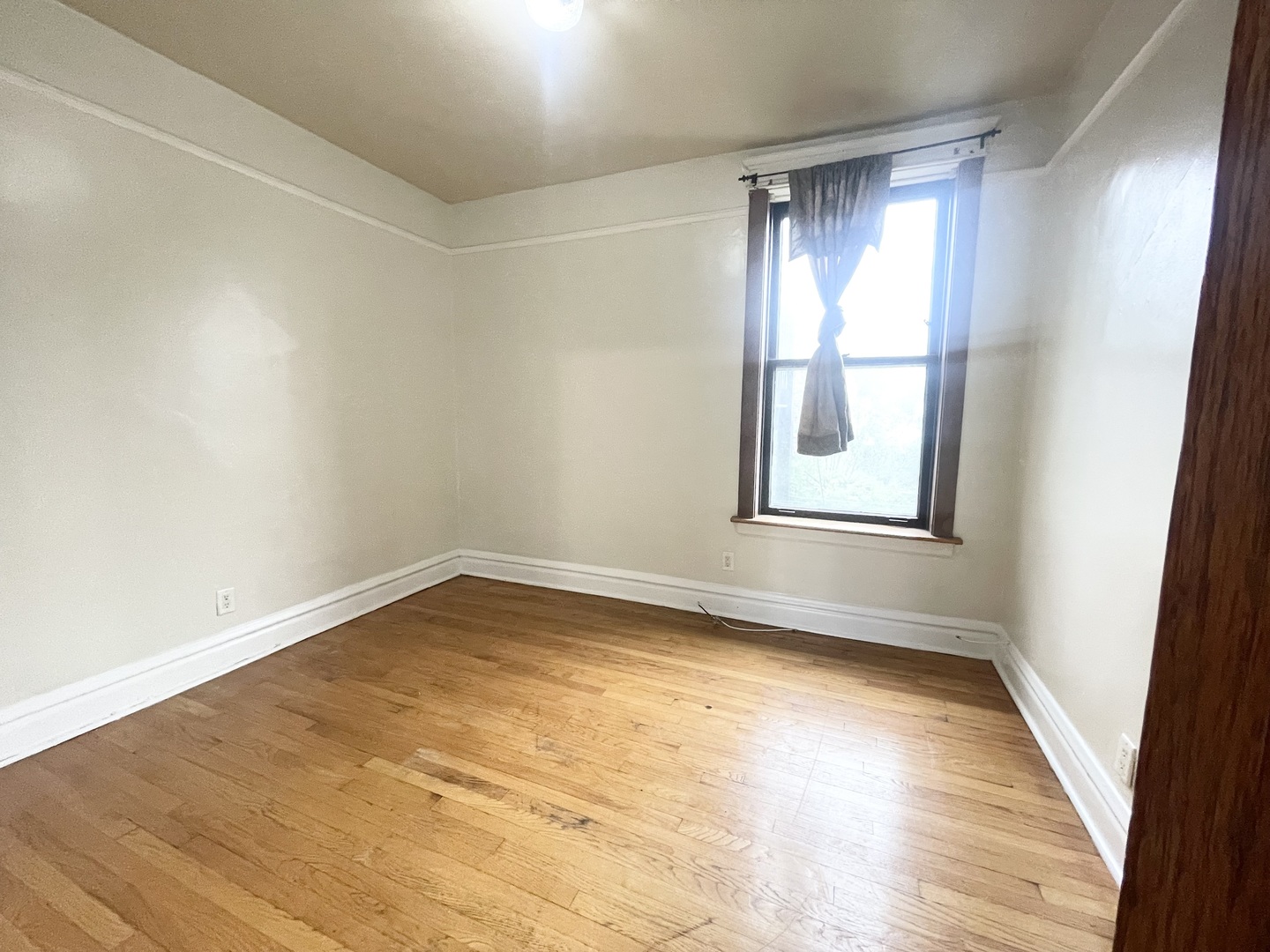 3270 West Dickens Avenue, Unit 2 Chicago, IL 60647 - Photo 8 of 15 a view of empty room with wooden floor and fan