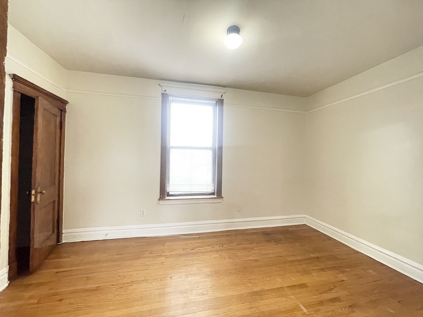 3270 West Dickens Avenue, Unit 2 Chicago, IL 60647 - Photo 10 of 15 an empty room with wooden floor and windows