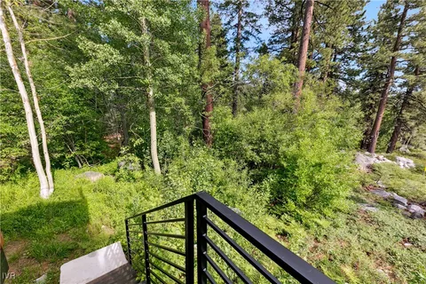 an aerial view of a house with swimming pool and sitting area