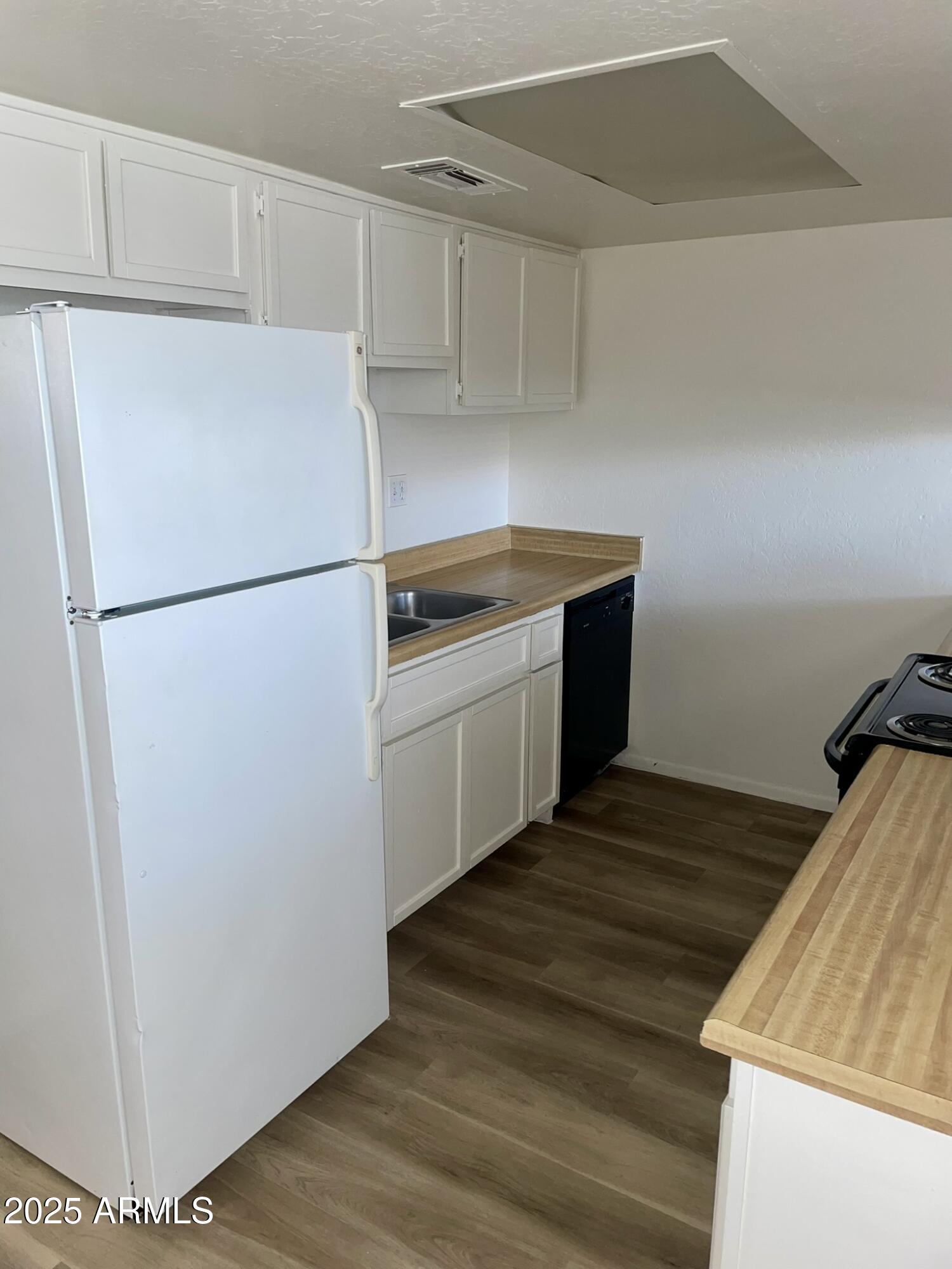 2002 East Sweetwater Avenue, Unit 202 Phoenix, AZ 85022 - Photo 5 of 22 a kitchen with a refrigerator and a stove