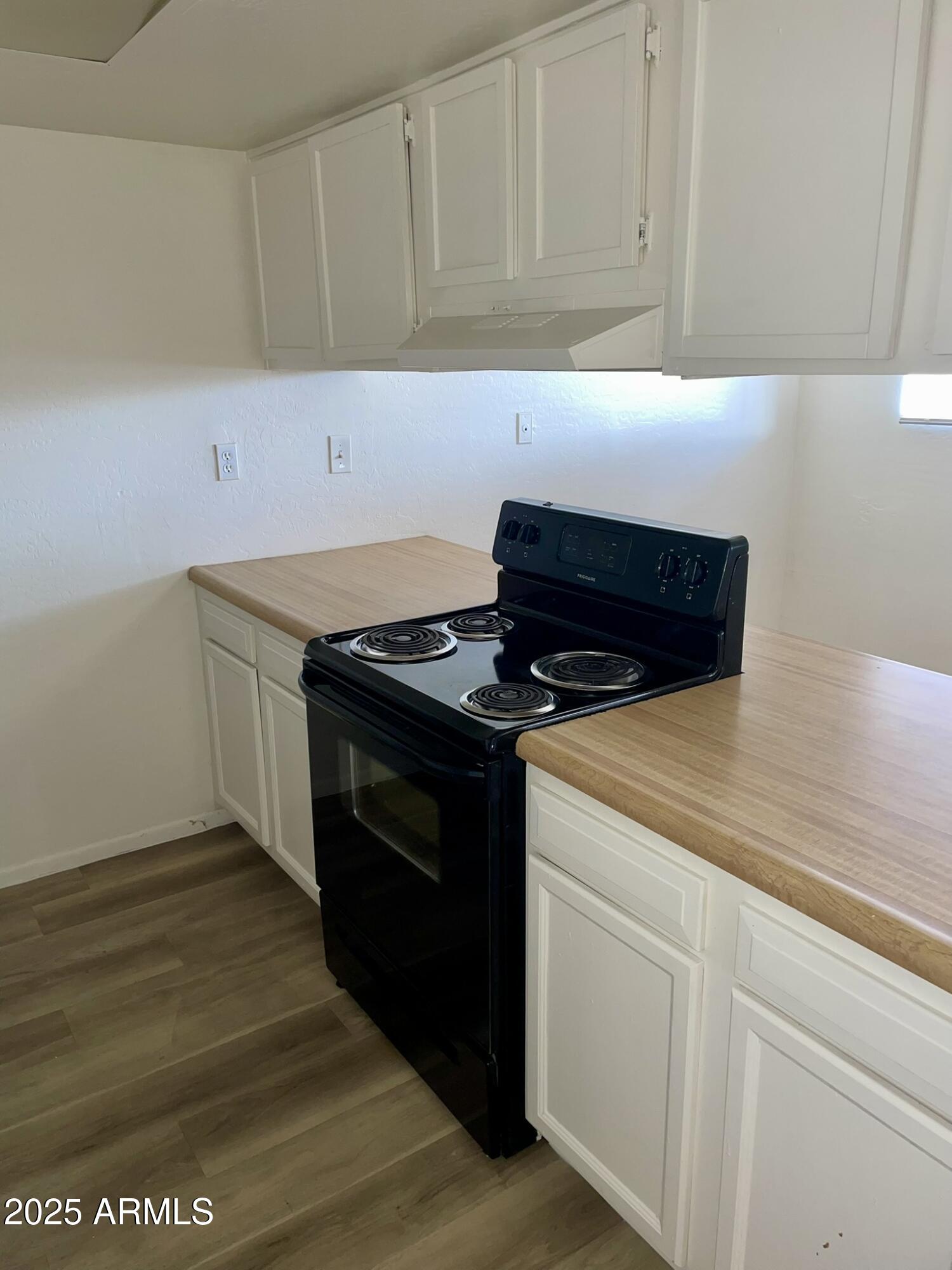 2002 East Sweetwater Avenue, Unit 202 Phoenix, AZ 85022 - Photo 6 of 22 a kitchen with granite countertop white cabinets and black appliances