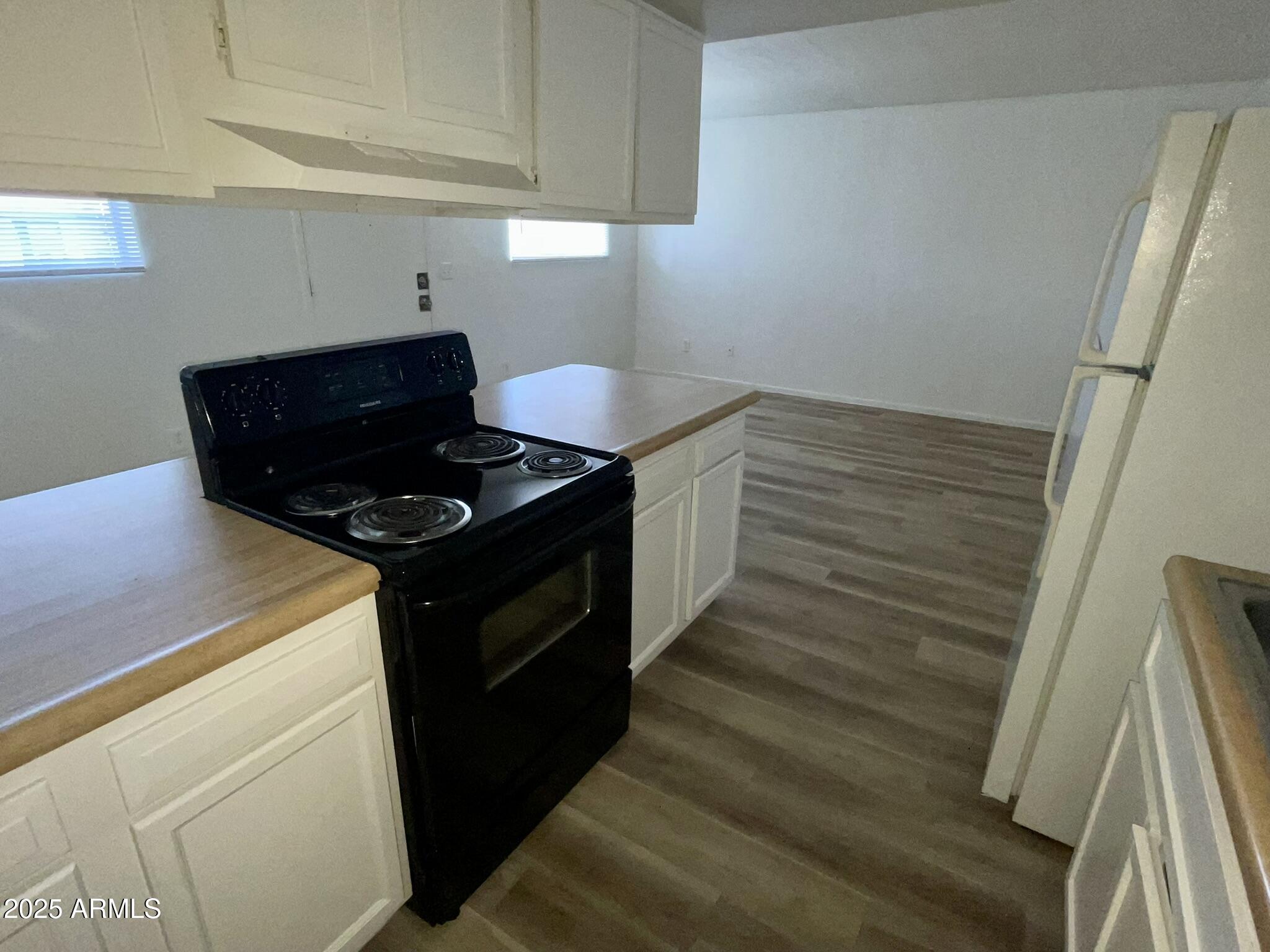 2002 East Sweetwater Avenue, Unit 202 Phoenix, AZ 85022 - Photo 8 of 22 a kitchen with wooden cabinets and a stove