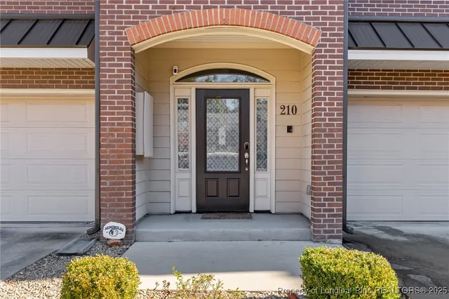 a lobby with furniture and a potted plant