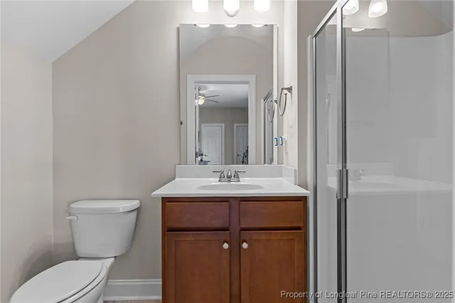 a kitchen with stainless steel appliances granite countertop a refrigerator a sink dishwasher a stove and white cabinets with wooden floor