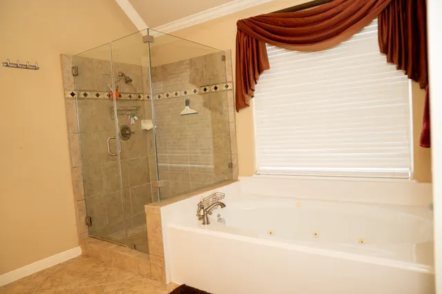 a bathroom with a bathtub and shower