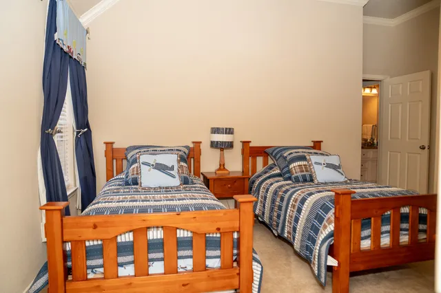 a bedroom with two beds and painted walls