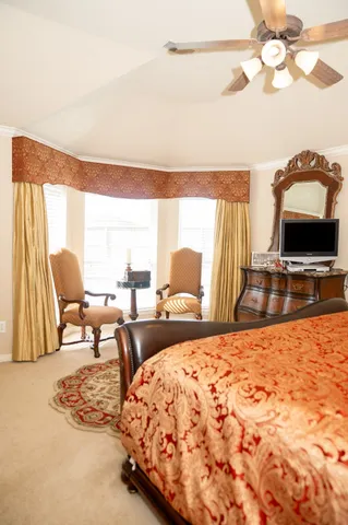 a living room with a bed furniture and a flat screen tv