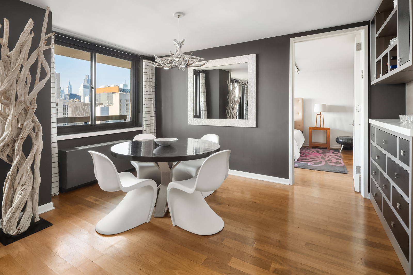 515 East 72nd Street, Unit 32C Manhattan, NY 10021 - Photo 3 of 15 a dining room with furniture and window