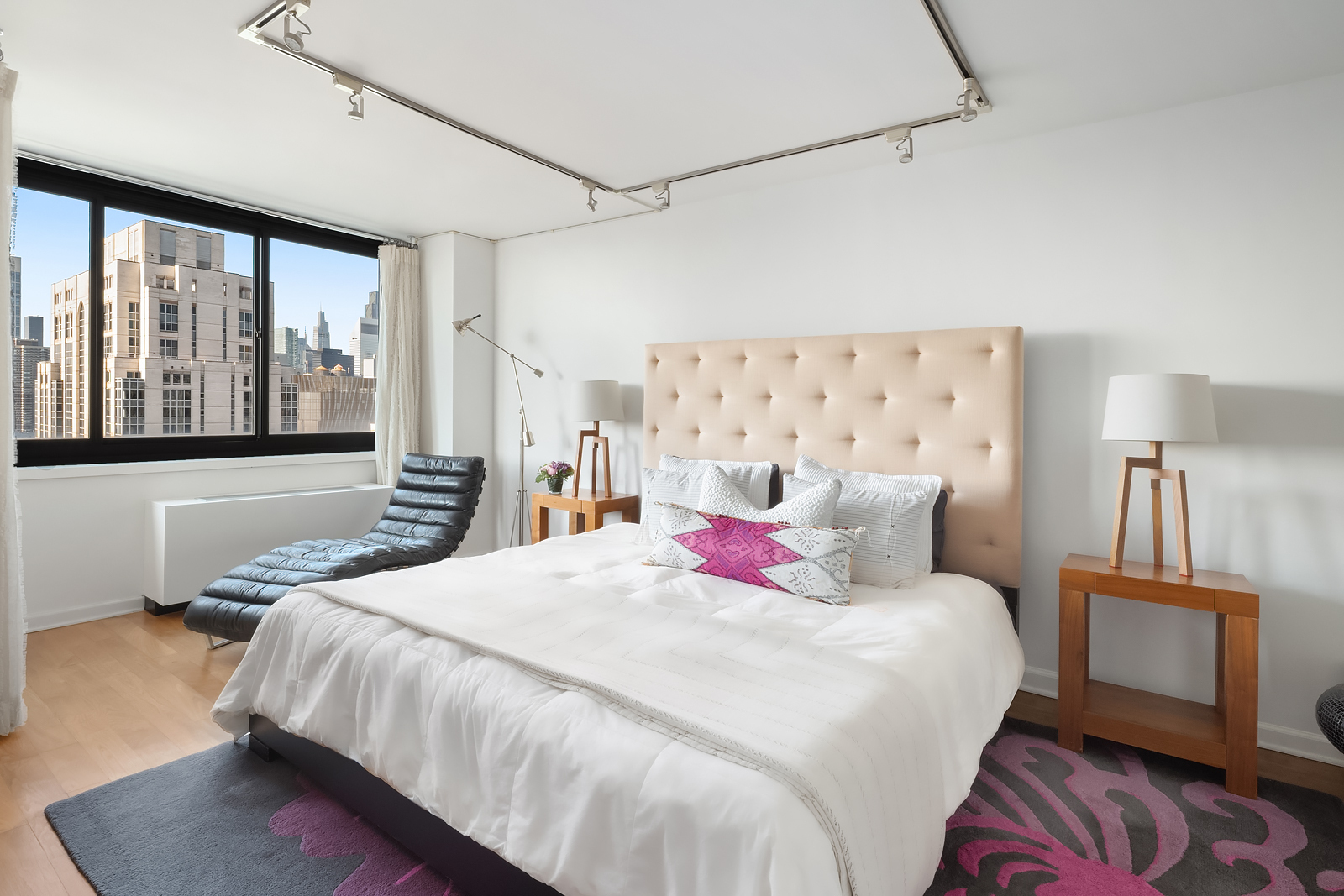 515 East 72nd Street, Unit 32C Manhattan, NY 10021 - Photo 6 of 15 a bedroom with a bed and wooden floor