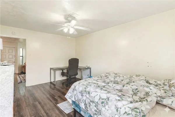 a bedroom with a bed and a table in it