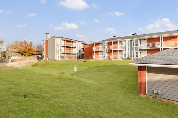 a view of a house with a yard and sitting area
