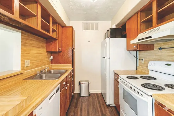 a kitchen with a sink a stove and refrigerator