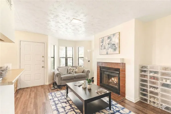 a living room with furniture a fireplace and a table