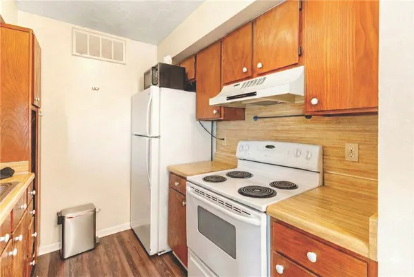 a kitchen with a stove and a refrigerator