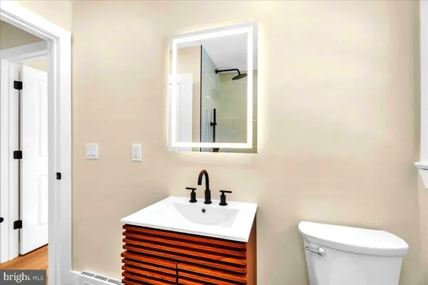 a white toilet sitting next to a bathroom sink
