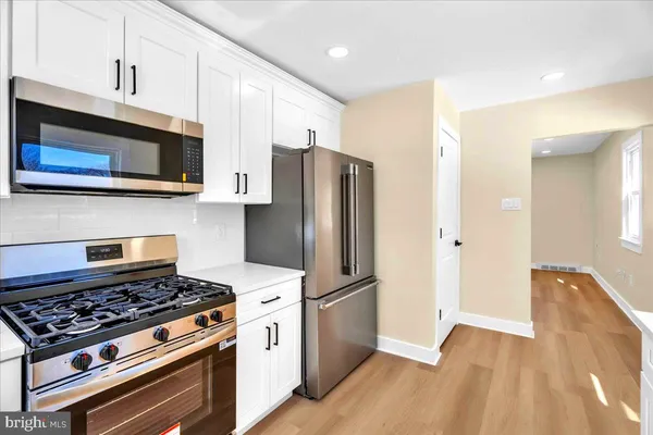 a kitchen with stainless steel appliances and wooden cabinets