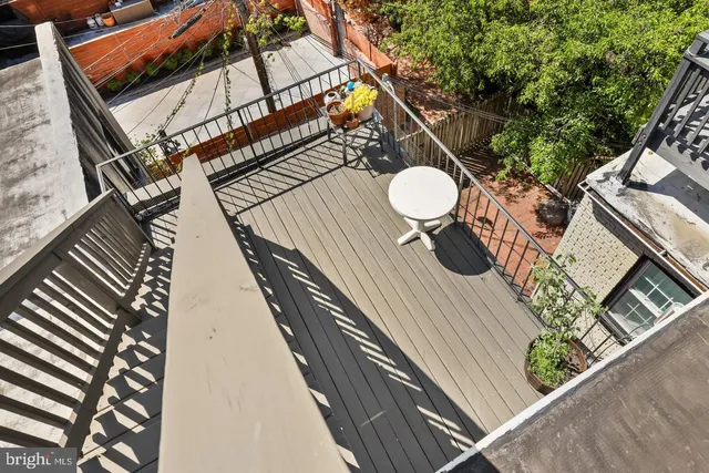 a view of a balcony with wooden floor