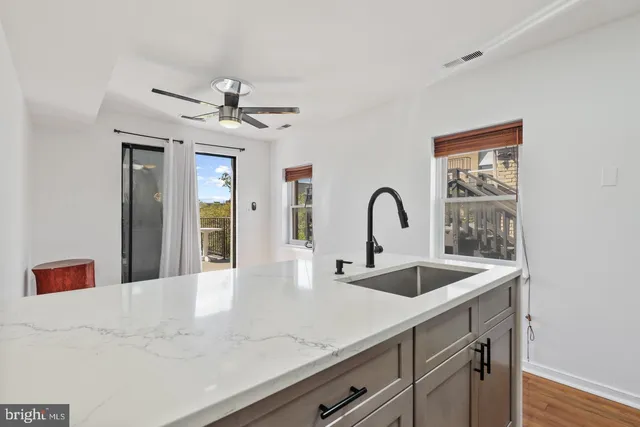 a view of a kitchen with a sink and chandelier