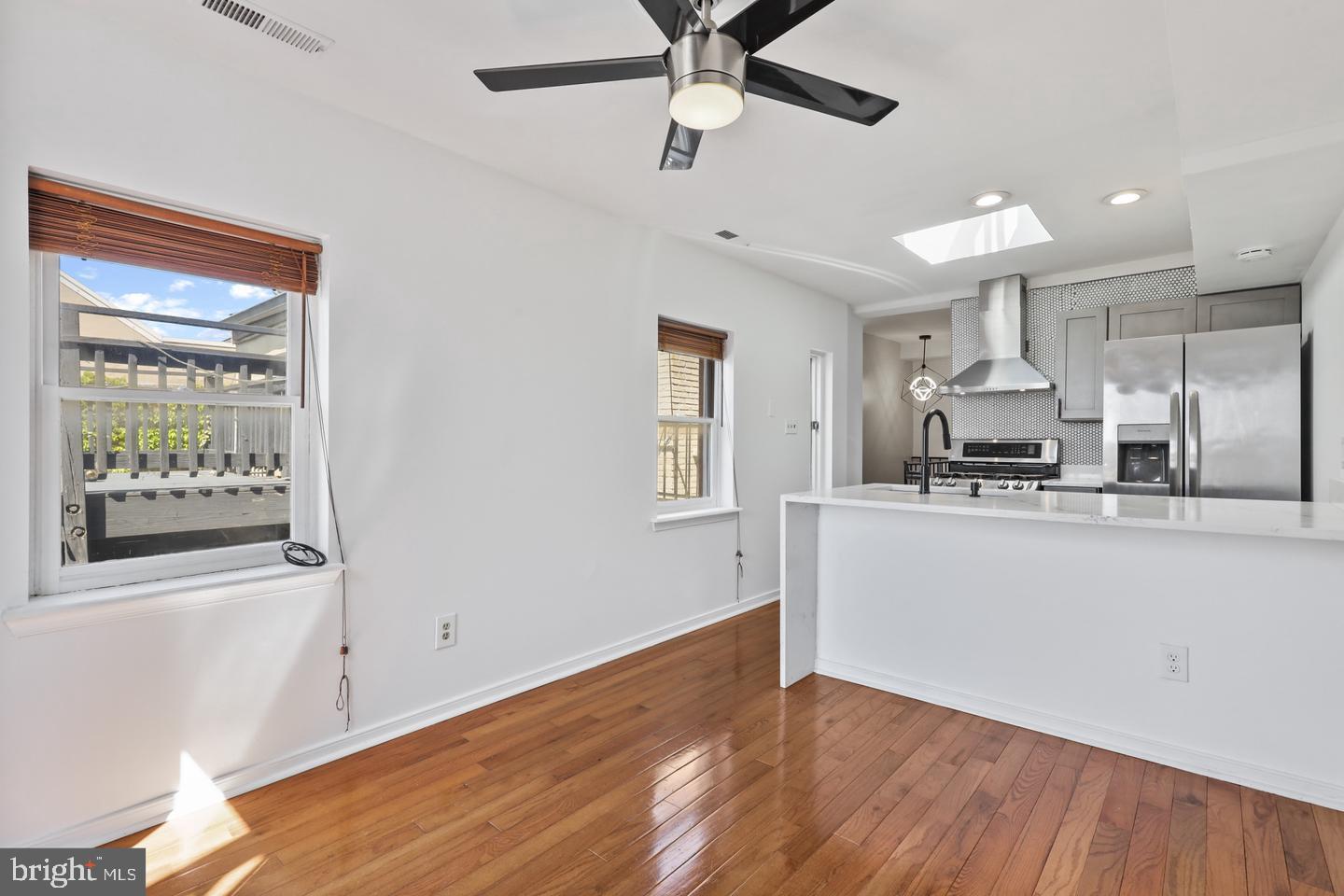 730 Light Street, Unit C Baltimore, MD 21230 - Photo 6 of 19 a view of a kitchen with a sink wooden floor and a window