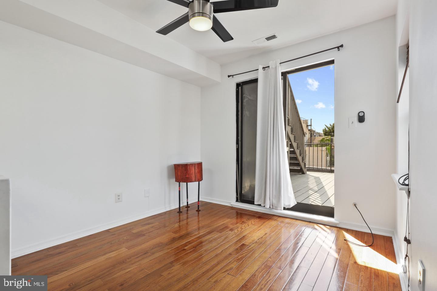 730 Light Street, Unit C Baltimore, MD 21230 - Photo 7 of 19 a view of empty room with wooden floor and fan