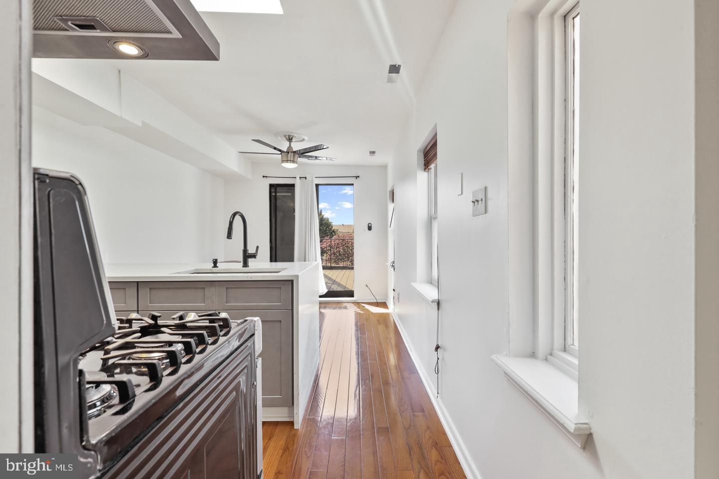 730 Light Street, Unit C Baltimore, MD 21230 - Photo 8 of 19 a view of a kitchen with a stove wooden floor and a refrigerator