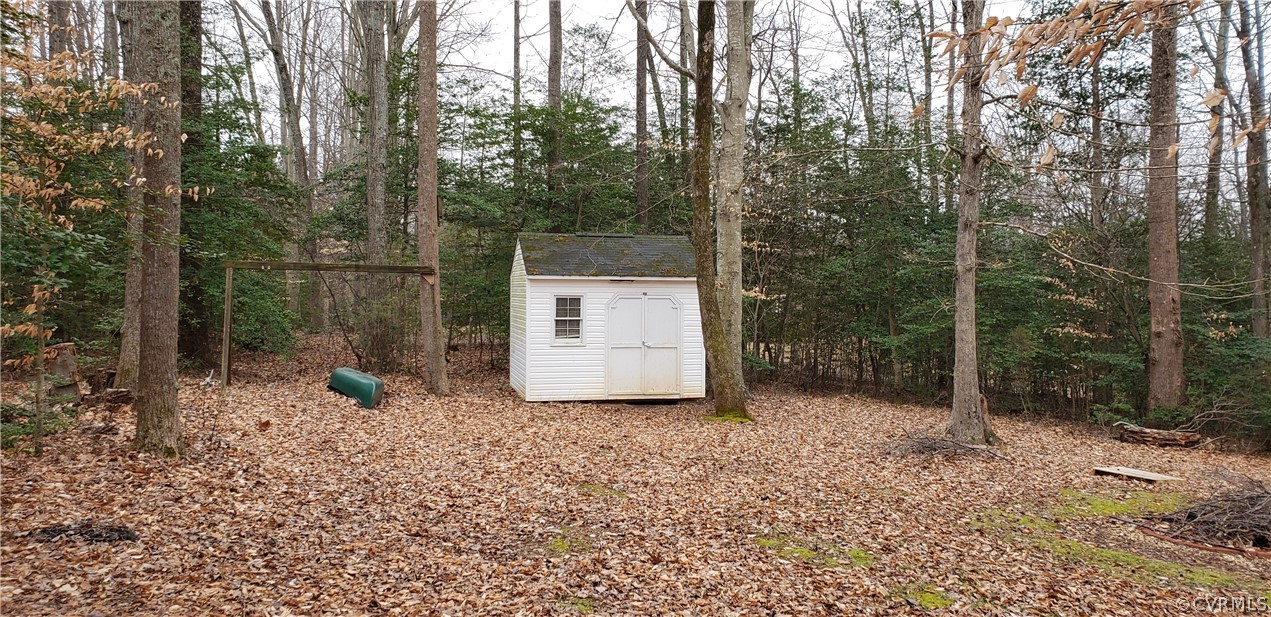3963 Cedar Plains Road Sandy Hook, VA 23153 - Photo 11 of 12 a view of a sink in the middle of a forest