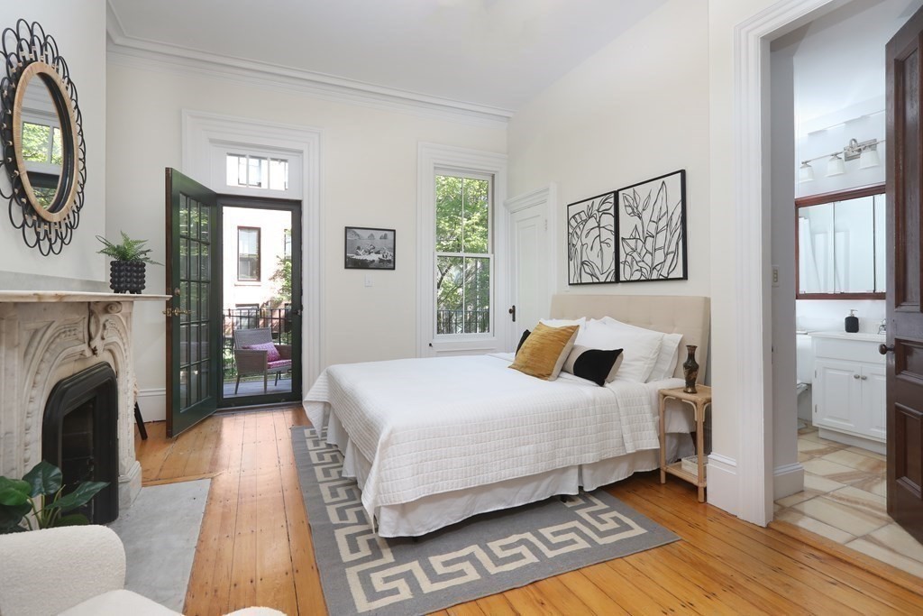 35 Milford Street, Unit 2 Boston, MA 02118 - Photo 7 of 12 a bedroom with a bed and a fireplace