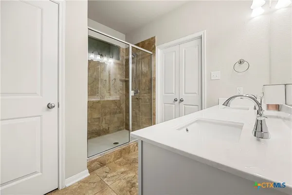a bathroom with a sink and a shower