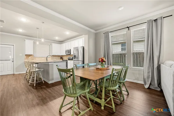 a view of a dining room with furniture and wooden floor