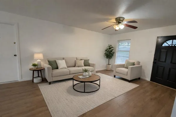 a living room with furniture and a lamp