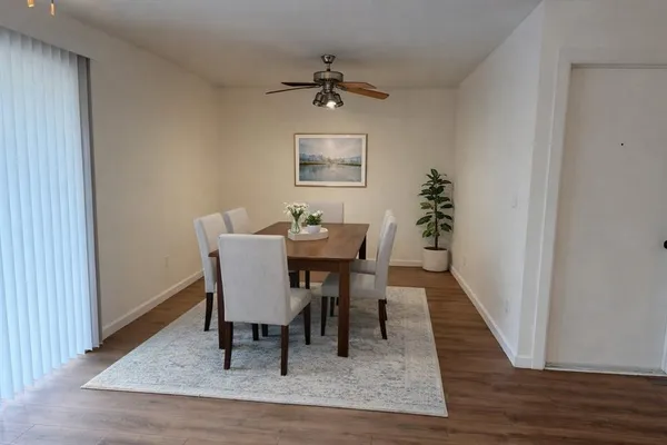 a view of a dining room with furniture and wooden floor