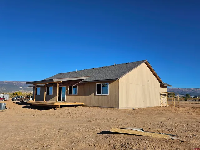 a view of a house with a wooden fence