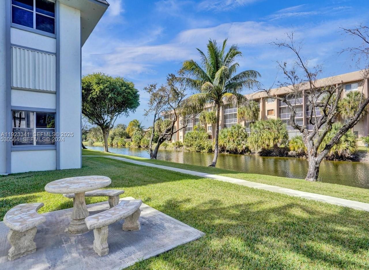 a backyard of a house with table and chairs