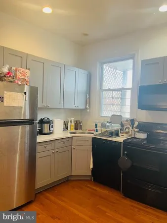 a kitchen with refrigerator and cabinets